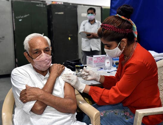 NEW DELHI, INDIA - JULY 23: A health worker administers a dose of Covid-19 vaccine to a beneficiary at SKV School, Mata Sundari Road DDU Marg, on July 23, 2021 in New Delhi, India. (Photo by Sonu Mehta Hindustan Times) COVID-19 Vaccination Drive