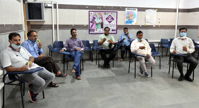 NEW DELHI, INDIA - JULY 23: Beneficiaries sit in an observation room after receiving a second Covid-19 vaccine dose at SKV School, Mata Sundari Road DDU Marg, on July 23, 2021 in New Delhi, India. (Photo by Sonu Mehta Hindustan Times) COVID-19 Vaccination Drive
