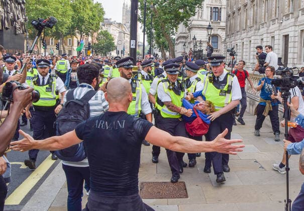 July 24, 2021, London, United Kingdom: Police arrest a protester in Whitehall during the demonstration..Thousands of protesters gathered in Westminster to protest against COVID-19 vaccinations, vaccine passports, and coronavirus restrictions, with many demonstrators calling the pandemic a hoax London United Kingdom - ZUMAs197 20210724_zaa_s197_210 Copyright: xVukxValcicx