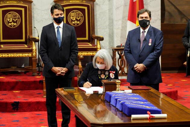 July 26, 2021, Ottawa, on, Canada: Mary Simon signs documents as Prime Minister Justin Trudeau (left) and chief justic Rihard Wagner look on after she took the oath to become the 30th governor general of Canada in Ottawa on Monday, July 26, 2021. Ottawa Canada  - ZUMAc35_ 20210726_zaf_c35_073 Copyright: xPaulxChiassonx