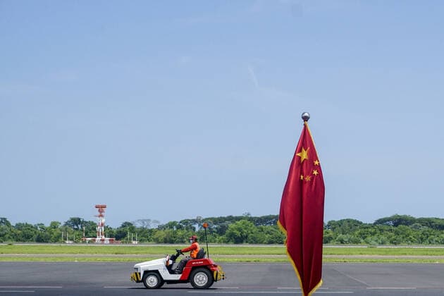 July 26, 2021, San Luis Talpa, El Salvador: An airport worker drives a car next to a Chinese flag set for a press conference. El Salvador received a new shipment containing 1 million vaccine doses of the CORONAVAC COVID-19 vaccine. San Luis Talpa El Salvador - ZUMAf143 20210726_zip_f143_011 Copyright: xCamiloxFreedmanx