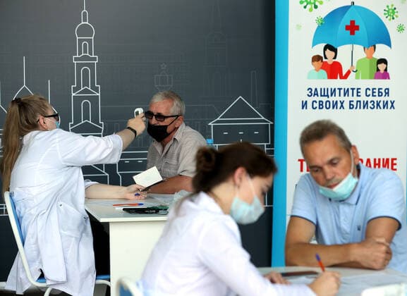 IVANOVO, RUSSIA - JULY 27, 2021: People undergo a medical checkup ahead of receiving COVID-19 vaccines at a mobile vaccination center at a railway station. Vladimir Smirnov TASS  TS109CC5