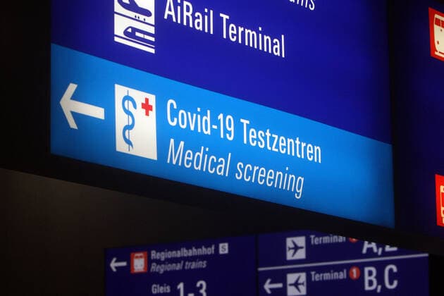 Directional sign with arrow pointing in the direction of the Covid 19 test centers with Centogene smear center in Frankfurt Airport, Hesse, Germany