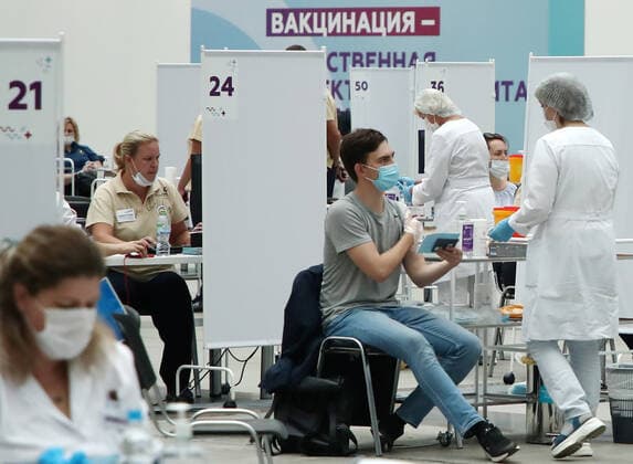 MOSCOW, RUSSIA - JULY 29, 2021: Citizens visit the largest Russian COVID-19 vaccination site set up at the Gostiny Dvor Exhibition Centre, oncology patients also given injections. Anton Novoderezhkin TASS  TS10A40A