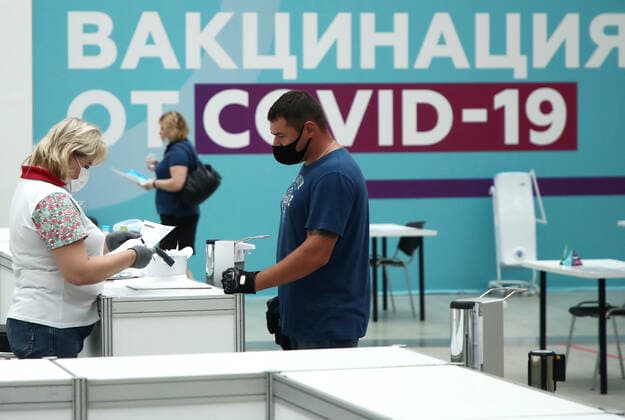 MOSCOW, RUSSIA - JULY 29, 2021: A man visits the largest Russian COVID-19 vaccination site set up at the Gostiny Dvor Exhibition Centre, oncology patients also given injections. Anton Novoderezhkin TASS  TS10A41D