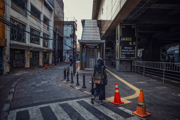 Jokowi Claims Effectiveness Of PPKM; No Need For Lockdown A woman walks through an empty station area during the emergency public activity restriction (PPKM) in Jakarta on 30 July 2021. President Joko Jokowi Widodo on Friday claimed the emergency public activity restriction (PPKM) the government imposed on July 3-20 and extends until August 2, was effective in reducing COVID-19 cases. He asserted that the government would never consider enacting a lockdown. Indonesia is currently adopting a level-based PPKM restriction with slackened regulations for several micro business sectors. Jakarta Indonesia hikmal-notitle210730_nprfm  Copyright: xAfriadixHikmalx