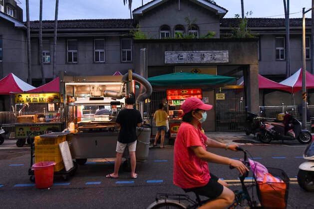 July 30, 2021, Taipei, Taiwan: A pedestrian wearing a face mask seen passing through Wanhua Night Market amid covid-19 pandemic..As the number of confirmed coronavirus cases has continued to dip lately, Central Epidemic Command Center (CECC) said that the CECC is planning to draw up epidemic management guidance for restaurants and night markets that would allow them to reopen. Taipei Taiwan - ZUMAs197 20210730_zab_s197_013 Copyright: xShihxHsunxChaox