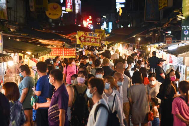 July 29, 2021, Taipei, Taiwan: Pedestrians wearing face masks as a preventive measure against the spread of covid-19 seen walking in Miauko Night Market in Keelung amid covid-19 pandemic..As the number of confirmed coronavirus cases has continued to dip lately, Central Epidemic Command Center (CECC) said that the CECC is planning to draw up epidemic management guidance for restaurants and night markets that would allow them to reopen. Taipei Taiwan - ZUMAs197 20210729_zab_s197_081 Copyright: xShihxHsunxChaox