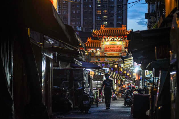 July 30, 2021, Taipei, Taiwan: A pedestrian wearing a face mask seen passing through Wanhua Night Market..As the number of confirmed coronavirus cases has continued to dip lately, Central Epidemic Command Center (CECC) said that the CECC is planning to draw up epidemic management guidance for restaurants and night markets that would allow them to reopen. Taipei Taiwan - ZUMAs197 20210730_zab_s197_015 Copyright: xShihxHsunxChaox