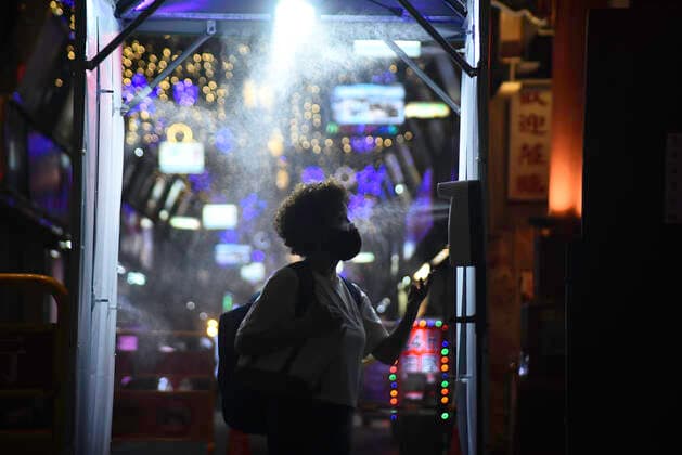 July 30, 2021, Taipei, Taiwan: A woman seen passing through a disinfection door in Wanhua night market amid covid-19 pandemic..As the number of confirmed coronavirus cases has continued to dip lately, Central Epidemic Command Center (CECC) said that the CECC is planning to draw up epidemic management guidance for restaurants and night markets that would allow them to reopen. Taipei Taiwan - ZUMAs197 20210730_zab_s197_017 Copyright: xShihxHsunxChaox
