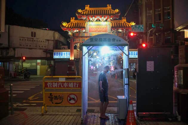 July 30, 2021, Taipei, Taiwan: A man seen passing through a disinfection door in Wanhua night market amid covid-19 pandemic..As the number of confirmed coronavirus cases has continued to dip lately, Central Epidemic Command Center (CECC) said that the CECC is planning to draw up epidemic management guidance for restaurants and night markets that would allow them to reopen. Taipei Taiwan - ZUMAs197 20210730_zab_s197_018 Copyright: xShihxHsunxChaox