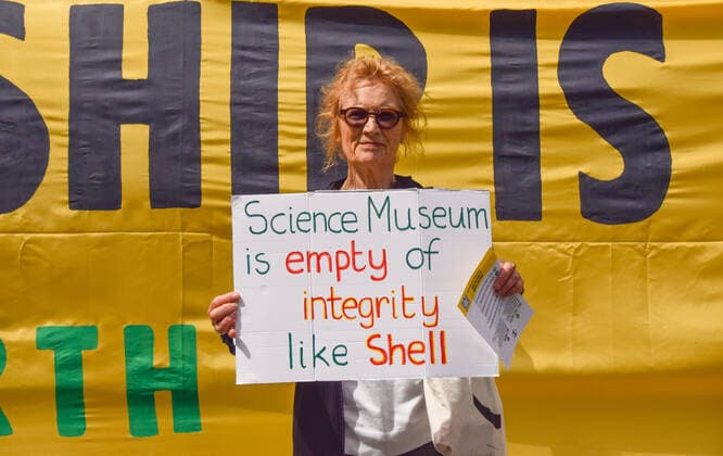 July 31, 2021, London, United Kingdom: A demonstrator holds a placard critical of the Science Museum and Shell during the anti-Shell sponsorship protest..Extinction Rebellion activists gathered once again outside the museum in South Kensington as part of their ongoing protest against oil giant Shell s sponsorship of the Our Future Planet climate change exhibition. London United Kingdom - ZUMAs197 20210731_zaa_s197_069 Copyright: xVukxValcicx
