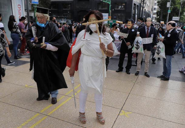 March In Favor Of The First Popular Consultation In Mexico Ends In Riots A woman in a disguise alluding to justice and other people accompanying her, marched in the streets of the Zocalo in Mexico City, to promote the First Popular Consultation to be held this Sunday 1 August during the COVID-19 health emergency and the orange epidemiological traffic light in the capital, where citizens will be asked whether or not they agree with the possibility of opening criminal proceedings against those who governed in the past. Mexico City Mexico vieyra-notitle210731_npbu3  Copyright: xGerardoxVieyrax