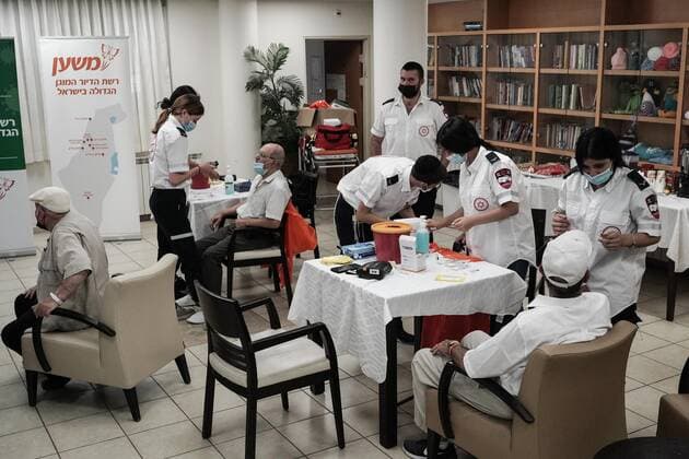 August 2, 2021, Jerusalem, Israel: Paramedics from Magen David Adom, serving as the Israeli Red Cross organization and leading EMS, deliver a 3rd BioNTech Pfizer booster vaccine to seniors at the Mishan Gonen Assisted Living Residence for the elderly. PM Bennett announced his goal of vaccinating all Israeli seniors, 60 and above, with a 3rd vaccine by the end of August 2021, in spite of the fact that a booster shot has not yet been approved by the US FDA. Jerusalem Israel - ZUMAa126 20210802_zap_a126_018 Copyright: xNirxAlonx
