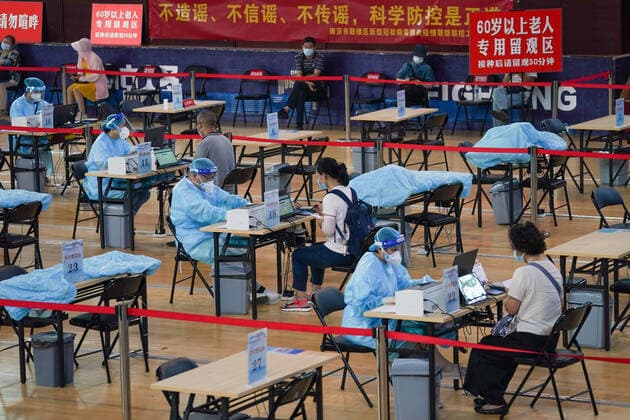 (210802) -- NANJING, Aug. 2, 2021 -- Residents register before getting inoculated against the COVID-19 virus at a vaccination site in a stadium in Nanjing, capital of east China s Jiangsu Province, Aug. 2, 2021. The city of Nanjing has been organizing vaccinations from Sunday for those who are qualified to get the second shot in low-risk areas amid resurgence of COVID-19 infections. ) CHINA-JIANGSU-NANJING-COVID-19-VACCINATION (CN) LixBo 