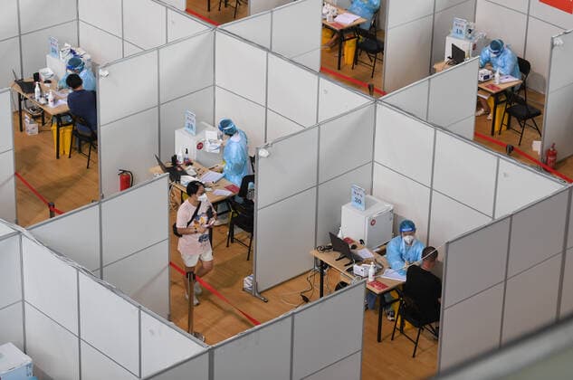 (210802) -- NANJING, Aug. 2, 2021 -- Residents get inoculated against the COVID-19 virus at a vaccination site in a stadium in Nanjing, capital of east China s Jiangsu Province, Aug. 2, 2021. The city of Nanjing has been organizing vaccinations from Sunday for those who are qualified to get the second shot in low-risk areas amid resurgence of COVID-19 infections. ) CHINA-JIANGSU-NANJING-COVID-19-VACCINATION (CN) JixChunpeng 