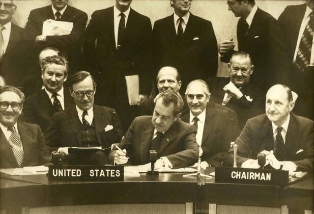 Jun. 26, 1974 - Brussels, Belgium - US President RICHARD NIXON, center, stopped in Brussels in order to sign the new Atlantic Charter, along with 14 other government officials, negotiated on June 19 in Ottawa and replaced the former 25 year old charter. Surrounded by HENRY KISSINGER (left) and Secretary General of NATO Mr. JOSEPH LUNS (right), President Nixon signs the Atlantic Charter. Brussels Belgium - ZUMAk09_ 19740626_baf_k09_005 Copyright: xKeystonexPressxAgencyx