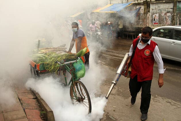 August 3, 2021, Dhaka, Dhaka, Bangladesh: A worker sprays pesticide to kill mosquitoes around a rickshaw driver in Dhaka. More then 200 people with dengue fever were admitted to hospitals in the country during 24 hours. Dhaka Bangladesh - ZUMAj163 20210803_zip_j163_008 Copyright: xAbuxSufianxJewelx