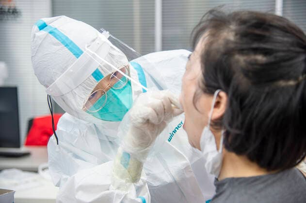 (210803) -- WUHAN, Aug. 3, 2021 -- A medical worker takes a swab sample from a resident for COVID-19 nucleic acid testing in Wuhan, central China s Hubei Province, Aug. 3, 2021. Wuhan City, capital of central China s Hubei Province, launched another citywide COVID-19 nucleic acid testing campaign on Tuesday, according to a press conference held by the provincial COVID-19 prevention and control headquarters. Wuhan, once hard-hit by COVID-19, identified new local clusters of cases on Monday when seven migrant workers at the Wuhan Economic & Technological Development Zone tested positive for the coronavirus. (Photo by Xinhua) CHINA-HUBEI-WUHAN-COVID-19-TESTING (CN) WuxZhizun