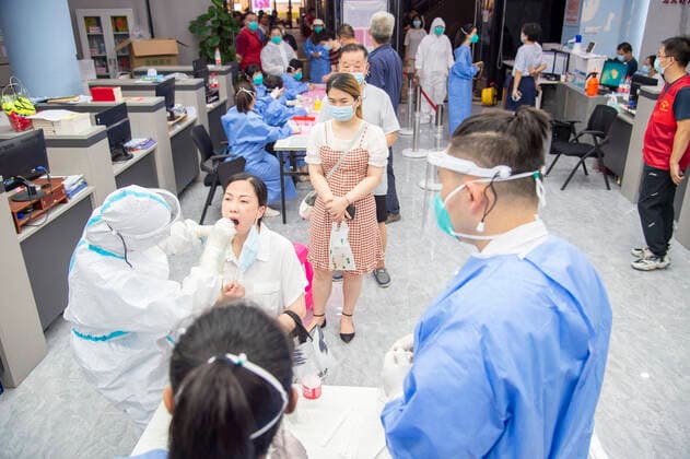 (210803) -- WUHAN, Aug. 3, 2021 -- A medical worker takes a swab sample from a resident for COVID-19 nucleic acid testing in Wuhan, central China s Hubei Province, Aug. 3, 2021. Wuhan City, capital of central China s Hubei Province, launched another citywide COVID-19 nucleic acid testing campaign on Tuesday, according to a press conference held by the provincial COVID-19 prevention and control headquarters. Wuhan, once hard-hit by COVID-19, identified new local clusters of cases on Monday when seven migrant workers at the Wuhan Economic & Technological Development Zone tested positive for the coronavirus. (Photo by Xinhua) CHINA-HUBEI-WUHAN-COVID-19-TESTING (CN) WuxZhizun