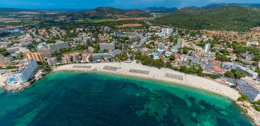 Aerial view, sandy beach Playa de Palmanova, beach life and sunbathing with straw parasols in rows, colorful children water boats with slide, Palmanova, CalviÃ , Majorca, Balearic Islands, Spain ATTENTIONxMINESTHONORARx60xEURO