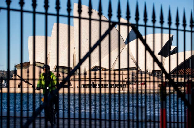 (210804) -- SYDNEY, Aug. 4, 2021 -- A woman rides a bike near Sydney Opera House in Sydney, Australia, Aug. 4, 2021. As of Tuesday afternoon, there had been 34,833 confirmed cases of COVID-19 in Australia, and the number of locally acquired cases in the previous 24 hours was 219, according to the latest figures from the Department of Health. Recently, the country s most populous city of Sydney in the state of New South Wales (NSW), continued to battle the outbreak of COVID-19 triggered by the Delta variant. ) AUSTRALIA-SYDNEY-COVID-19-CASES BaixXuefei