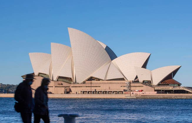 (210804) -- SYDNEY, Aug. 4, 2021 -- People walk near Sydney Opera House in Sydney, Australia, Aug. 4, 2021. As of Tuesday afternoon, there had been 34,833 confirmed cases of COVID-19 in Australia, and the number of locally acquired cases in the previous 24 hours was 219, according to the latest figures from the Department of Health. Recently, the country s most populous city of Sydney in the state of New South Wales (NSW), continued to battle the outbreak of COVID-19 triggered by the Delta variant. ) AUSTRALIA-SYDNEY-COVID-19-CASES BaixXuefei