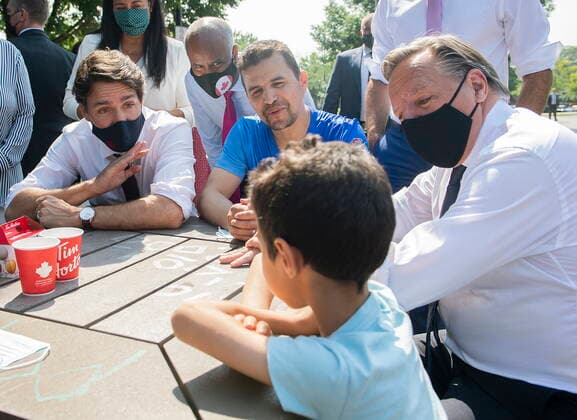 August 5, 2021, Montreal, PQ, Canada: Prime Minister Justin Trudeau and Quebec Premier Francois Legault, right, talk with a family prior to making a childcare investment announcement in Montreal, Thursday, August 5, 2021. Montreal Canada  - ZUMAc35_ 20210805_zaf_c35_046 Copyright: xGrahamxHughesx