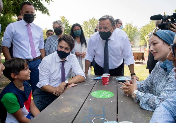 August 5, 2021, Montreal, PQ, Canada: Prime Minister Justin Trudeau, left seated, and Quebec Premier Francois Legault, right, talk with a family prior to making a childcare funding announcement in Montreal, Thursday, August 5, 2021. Montreal Canada - ZUMAc35_ 20210805_zaf_c35_050 Copyright: xGrahamxHughesx