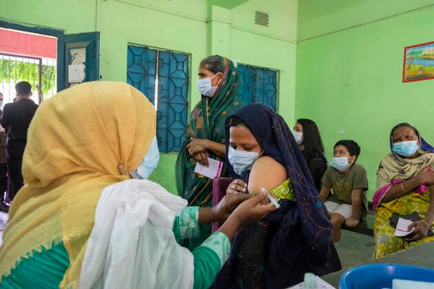 Bangladesh begins nationwide Covid-19 vaccination drive A healthcare worker injects Mosammat Poli with Moderna Covid-19 Vaccine. Dhaka Bangladesh Lalmatia Copyright: RizwanxHasan