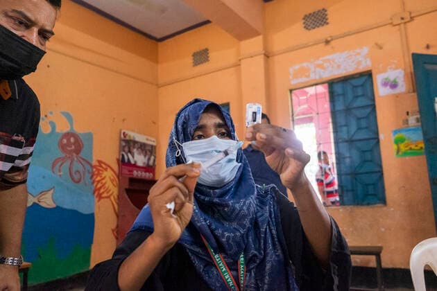 Bangladesh begins nationwide Covid-19 vaccination drive Healthcare worker inspects a syringe filled with Moderna Covid-19 Vaccine. Dhaka Bangladesh Lalmatia Copyright: RizwanxHasan