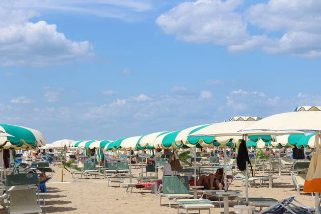 August 6, 2021, Rimini, Italy: Green pass doesn t stop Ferragosto, the Italians mid-August vacation on the beaches. In Rimini and Rivieira Romanhola region, the coast is starting to get crowded even with the green certificate being mandatory. And there are many tourists arriving in the city. Since the 6th of August, the Green Pass is mandatory in Italy. Green Pass is mandatory only to enter some closed places, such as restaurants and bars, if you intend to sit and eat at the table, but also in discos, museums, exhibitions, gyms, swimming pools, amusement parks, parties and health centers. The Government extended the mandatory green pass also for access to long-distance trains and planes. Copyright: xJosixDonellix