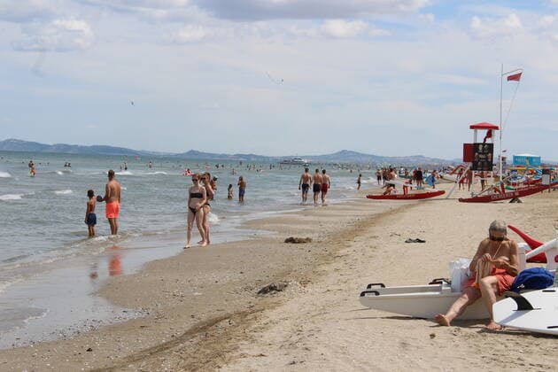 August 6, 2021, Rimini, Italy: Green pass doesn t stop Ferragosto, the Italians mid-August vacation on the beaches. In Rimini and Rivieira Romanhola region, the coast is starting to get crowded even with the green certificate being mandatory. And there are many tourists arriving in the city. Since the 6th of August, the Green Pass is mandatory in Italy. Green Pass is mandatory only to enter some closed places, such as restaurants and bars, if you intend to sit and eat at the table, but also in discos, museums, exhibitions, gyms, swimming pools, amusement parks, parties and health centers. The Government extended the mandatory green pass also for access to long-distance trains and planes. Copyright: xJosixDonellix