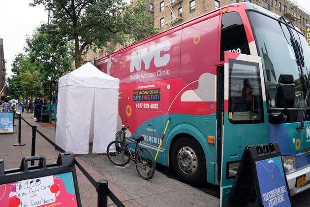 Mobile vaccination pop-up site in the Bronx Mobile vaccination pop-up site set up in the Bronx for COVID-19 vaccine available to passerby people at no cost with prepaid VISA $100 card as insensitive. City administration set up one hundred dollar insensitivity to get more people to get vaccinated amid surge of Delta variant and rise in the number of infections. The site is set by NNYC Health and Hospitals system and will remain for 3 days. They will retrun back for second dose jab on the same location in three weeks. New York New York United States Corner of West 231st street and Copyright: LevxRadin