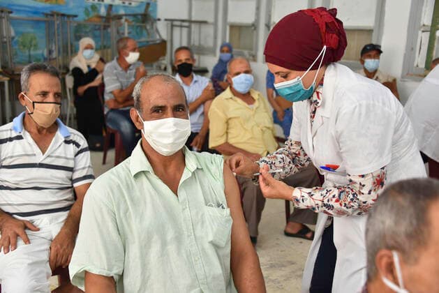 August 8, 2021, Tunis, Tunisia: A health worker administers the AstraZeneca vaccine to a Tunisian man at Oued Ellil high school in Manouba..The national Covid-19 vaccination day for people aged 40 and above started this Sunday, August 8, 2021, in various parts of Tunisia. Tunis Tunisia - ZUMAs197 20210808_zaa_s197_017 Copyright: xJdidixWassimx