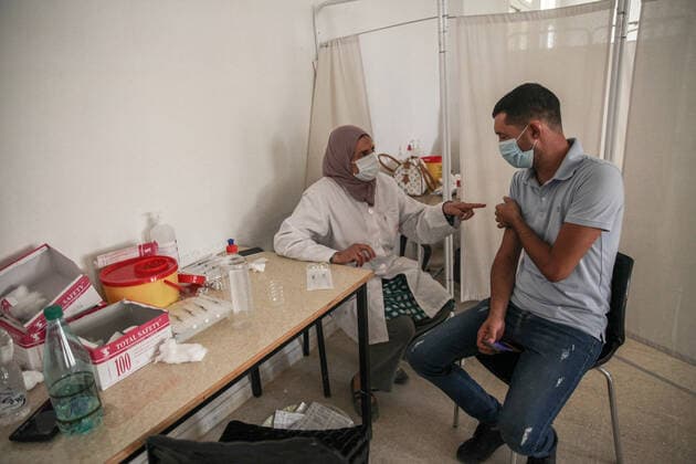 National COVID-19 Vaccination Campaign In Tunisia A man receives a dose of the AstraZeneca COVID-19 vaccine in the vaccination centre in the city of Ariana, near the capital Tunis, Tunisia, on August 8, 2021, as part of the national vaccination open days ordered by the Tunisian President Kais Saied for the benefit of all Tunisian citizens over 40 years old, as Tunisia struggles to stop the rapid spread of Coronavirus pandemic. Tunis TUNIS Tunisia benibrahim-national210808_np3R9  Copyright: xChedlyxBenxIbrahimx