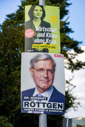 Theme image election poster of candidate for chancellor Annalena Baerbock, Bündnis 90 Die Grünen Below the poster of Dr Norbert Röttgen, CDU candidate for the Bundestag for the constituency Rhein Sieg Kreis II constituency 98 election posters for the Bundestag election campaign 2021 Wachtberg Niederbachem NRW Germany