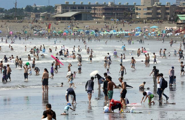August 11, 2021, Fujisawa, Japan - Katase Enoshima beach is crowded with bathers amid outbreak of the new coronavirus in Fujisawa, suburban Tokyo on Wednesday, August 11, 2021.  (166936597)