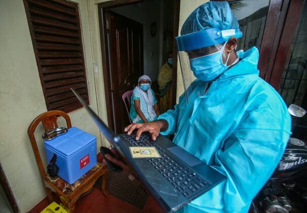 August 13, 2021, colombo, Sri Lanka: Sri Lankan Army health officials prepares to register a woman for receiving a dose of the Covid-19 coronavirus during a mobile vaccination drive by army health officials in Colombo on August 13, 2021. colombo Sri Lanka. - ZUMAd152 20210813_znp_d152_004 Copyright: xPradeepxDambaragex