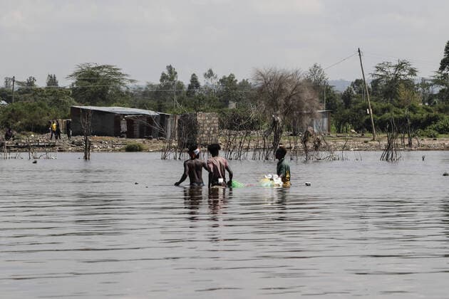 August 12, 2021, Nakuru, Rift Valley, Kenya: Fishermen are seen laying nets at a flooded area now part of Lake Nakuru..Fishing is outlawed on the lake but despite that, fishermen continue fishing risking arrest and prosecution..Lake Nakuru continued flooding has led to displacement of hundreds of people from their homes. Sources indicate lakes in Rift Valley are flooding because of the impact of climate change. Nakuru Kenya - ZUMAs197 20210812_zaa_s197_142 Copyright: xJamesxWakibiax