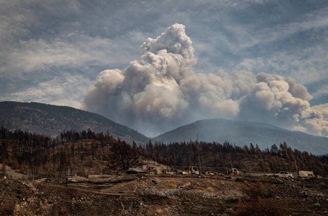August 15, 2021, LYTTON, BC, CANADA: Properties destroyed by the Lytton Creek wildfire on June 30 are seen as a pyrocumulus cloud, also known as a fire cloud, produced by the same fire rises in the mountains above Lytton, B.C., on Sunday, August 15, 2021. LYTTON CANADA - ZUMAc35_ 20210815_zaf_c35_073 Copyright: xDarrylxDyckx