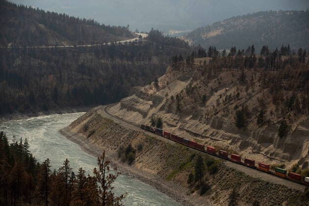 August 15, 2021, LYTTON, BC, CANADA: A Canadian Pacific freight train travels on tracks covered with fire retardant in an area burned by wildfire above the Thompson River near Lytton, B.C., on Sunday, August 15, 2021. LYTTON CANADA  - ZUMAc35_ 20210815_zaf_c35_080 Copyright: xDarrylxDyckx