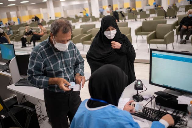 General COVID-19 Vaccination In Tehran An employee checks documents of an Iranian couple as they attend to receive a dose of the Iranian Coviran Barkat COVID-19 vaccine during the mass general COVID-19 vaccination in the Iran Grand Bazaar, Iran Mall, in western Tehran, August 17, 2021. Tehran Tehran Iran nikoubazl-generalc210817_npwQg  Copyright: xMortezaxNikoubazlx