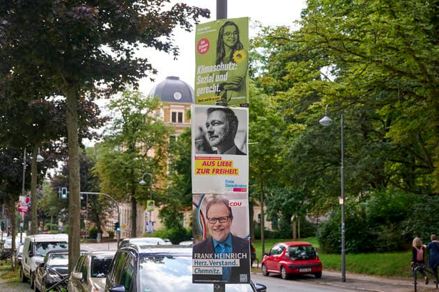 Election posters of the Greens, FDP, CDU at a lantern Chemnitz from 1953 to 1990 Karl Marx Stadt is an independent city in the southwest of the Free State of Saxony in Chemnitz, Germany on 15 08 2021