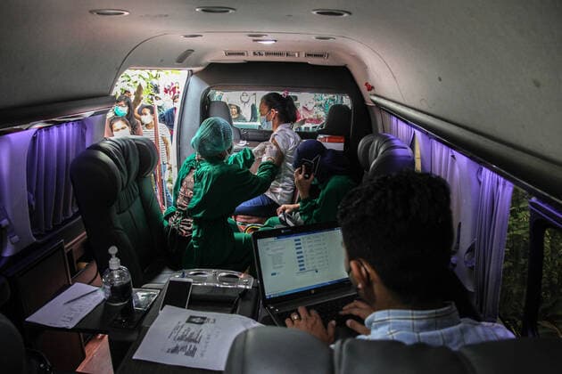 (210819) -- MEDAN, Aug. 19, 2021 -- A woman receives a dose of COVID-19 vaccine at a mobile vaccination site in Medan, North Sumatra, Indonesia, Aug. 19, 2021. (Photo by Xinhua) INDONESIA-MEDAN-COVID-19-MOBILE VACCINATION AlberthxDamanik 