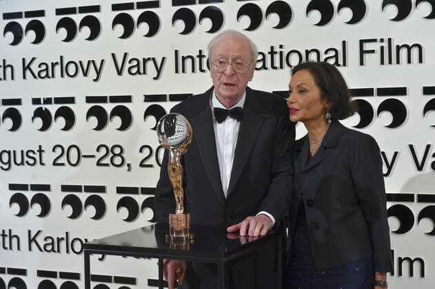 Karlovy Vary International Film Festival - Michael Caine erhält Auszeichnung für sein Lebenswerk Oscar-winning English actor Michael Caine receives award for his outstanding contribution to world cinema from President of Festival Jiri Bartoska (not pictured) at the 55th edition of the Karlovy Vary International Film Festival, Friday, August 20, 2021. The international film festival returns to the Czech spa of Karlovy Vary after two years due to a delay caused by the coronavirus pandemic. At right is wife of Michael Caine Shakira. (CTKxPhoto SlavomirxKubes) CTKPhotoP2021082006923 