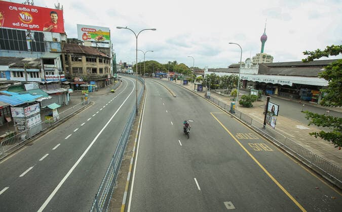 August 21, 2021, colombo, Sri Lanka: A man rides a moterbike through a deserted street during a nationwide 10-days lockdown imposed to curb the spread of Covid-19 coronavirus in Colombo, Sri Lanka on August 21, 2021. colombo Sri Lanka. - ZUMAd152 20210821_znp_d152_012 Copyright: xPradeepxDambaragex