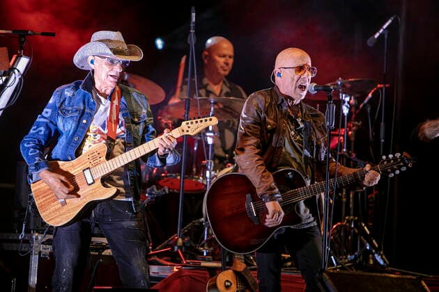 Fritz Puppel guitar , Roger Heinrich drums and Toni Krahl vocals, guitar L R from the group CITY founded 1972 in East Berlin GDR during the Candelight Open Air rock concert live in Coswig