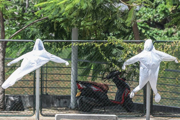 Sri Lanka: Government s vaccination program Personal protective equipment (PPE) kits had been hung on a fence to sun-dry in Colombo as the country is in a ten-day island-wide lockdown to curb the spread of Covid-19 on 23 August 2021. Colombo Western Province Sri Lanka Copyright: SamanxAbesiriwardana