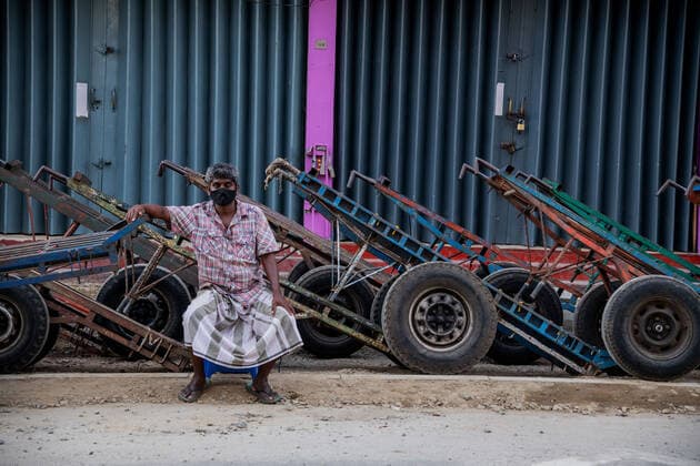 Sri Lanka: Third wave lockdown A man sitting on the cart in the empty roads during a nationwide 10-day lockdown imposed to curb the spread of Covid-19 coronavirus in the usually-bustling main commercial bazaar, Pettah, Colombo, Sri Lanka colombo Western Sri Lanka Copyright: VimukthixEmbuldeniya